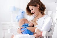 A mother feeds her infant. It is crucial to give babies mother's milk during the first six months.