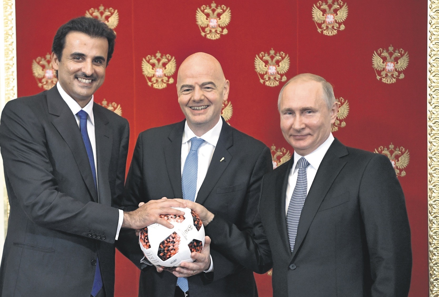 The Emir of Qatar Sheikh Tamim bin Hamad al-Thani (L), FIFA President Gianni Infantino and Russian President Vladimir Putin pose for a photo during their meeting in the Kremlin in Moscow, July 15.