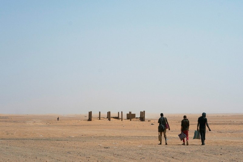 Three men head north towards Algeria after crossing the Assamaka border post in northern Niger on Sunday, June 3, 2018. (AP Photo)