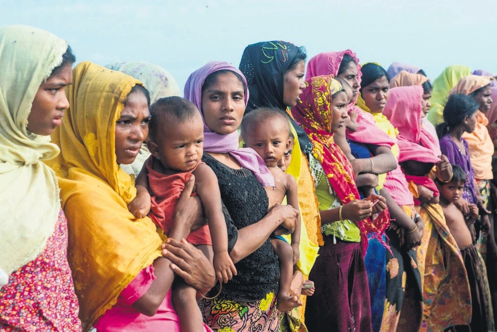 Rohingya women hold their children at a makeshift camp in Rakhine state, Myanmar, Nov. 12.