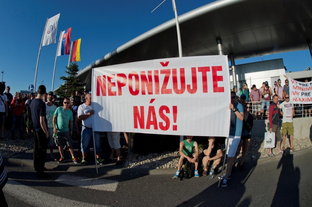 Volkswagen Slovakia employees attend a strike in demand of higher wages in Devinska Nova Ves near Bratislava, Slovakia, June 20. The banner reads: ,Do not humiliate us.,