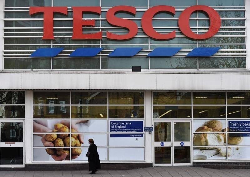 A woman walks past a Tesco supermarket in central London, December 9, 2014. (Reuters Photo)