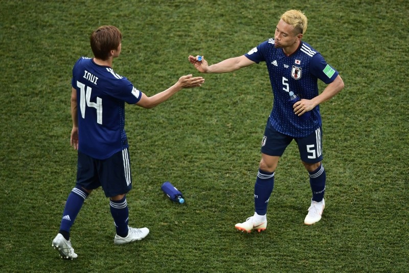 Japan's midfielder Takashi Inui (L) and Japan's defender Yuto Nagatomo (R) shake hands after the final whistle in the Russia 2018 World Cup Group H football match between Japan and Poland at the Volgograd Arena in Volgograd on June 28, 2018. (AFP)