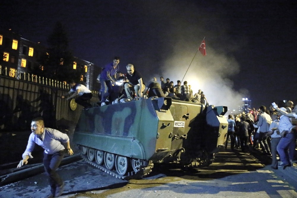 Anti-coup civilians protest against the coup attempt and surround a tank at military headquarters in Ankara on July 15, 2016. 