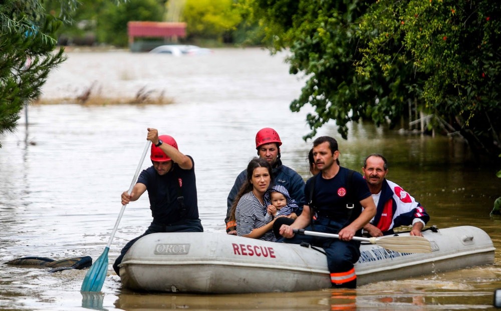 Fire fighters of Istanbul Metropolitan Municipality rescued people who trapped in their house due to flood with boats on July 27.