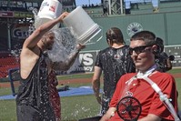 Boston Red Sox player Mike Napoli takes part in the re-launch of the Ice Bucket Challenge as former Boston College baseball player Pete Frates, right, looks on at Fenway Park in Boston, July 31, 2015. (AP Photo)
