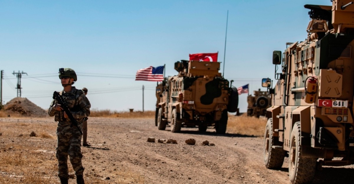 A US soldier stands guard during a joint patrol with Turkish troops in the Syrian village of al-Hashisha on the outskirts of Tal Abyad town along the border with Turkish troops, on September 8, 2019. (AFP Photo)