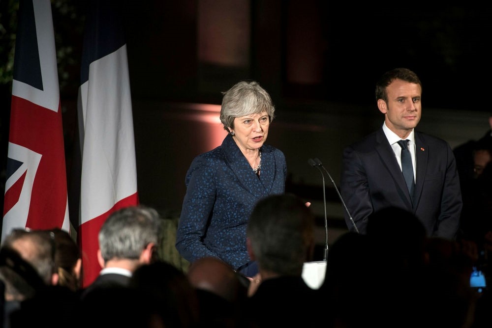 British Prime Minister Theresa May (L) and French President Emmanuel Macron (R) attend a reception at the Victoria and Albert Museum, Central London, Jan. 18.  