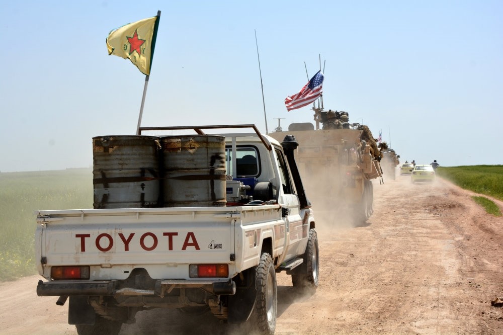 A convoy of U.S. army troops and militants from the PKK's Syrian affiliate the YPG patrol near al-Ghanamya, al-Darbasiyah along the Syrian-Turkish border, Syria, April 29.