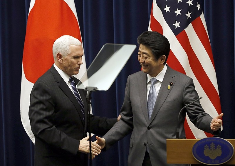 U.S. Vice President Mike Pence, left, and Japan's Prime Minister Shinzo Abe shake hands during their joint announcement after their meeting at Abe's official residence in Tokyo Wednesday, Feb. 7, 2018. (AP Photo)