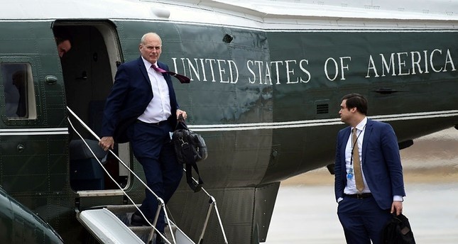 White House Chief of Staff John Kelly, left, walks off of Marine One as White House aide Johnny DeStefano, right, waits, as they arrive at Andrews Air Force Base in Md., with President Donald Trump, Friday, Feb. 16, 2018. (AP Photo)