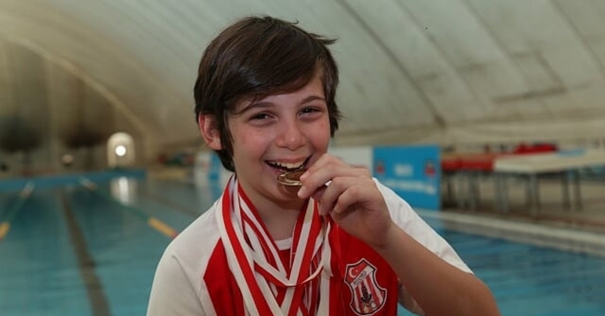 Koral Berkin Kutlu poses with his medal. The 13-year-old swimmer collected 39 medals in his short career.  