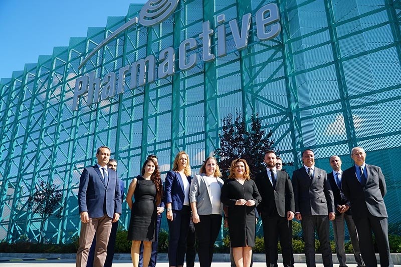 Pharmactive executives posing in front of company headquarters (DHA Photo)