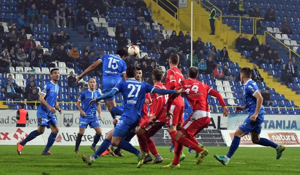 Footballers of Sarajevo's Zeljeznicar FC (blue jerseys) take part in a local match against Mladost FC (red jerseys).