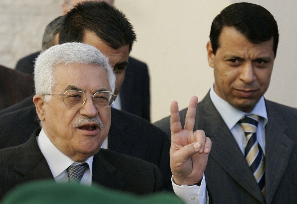 Palestinian Authority President Mahmoud Abbas is accompanied by former Fatah strongman Mohammad Dahlan in this archive photo (on left). Hamas, led by Ismail Haniyeh, extended an olive branch to the Abbas administration last week.