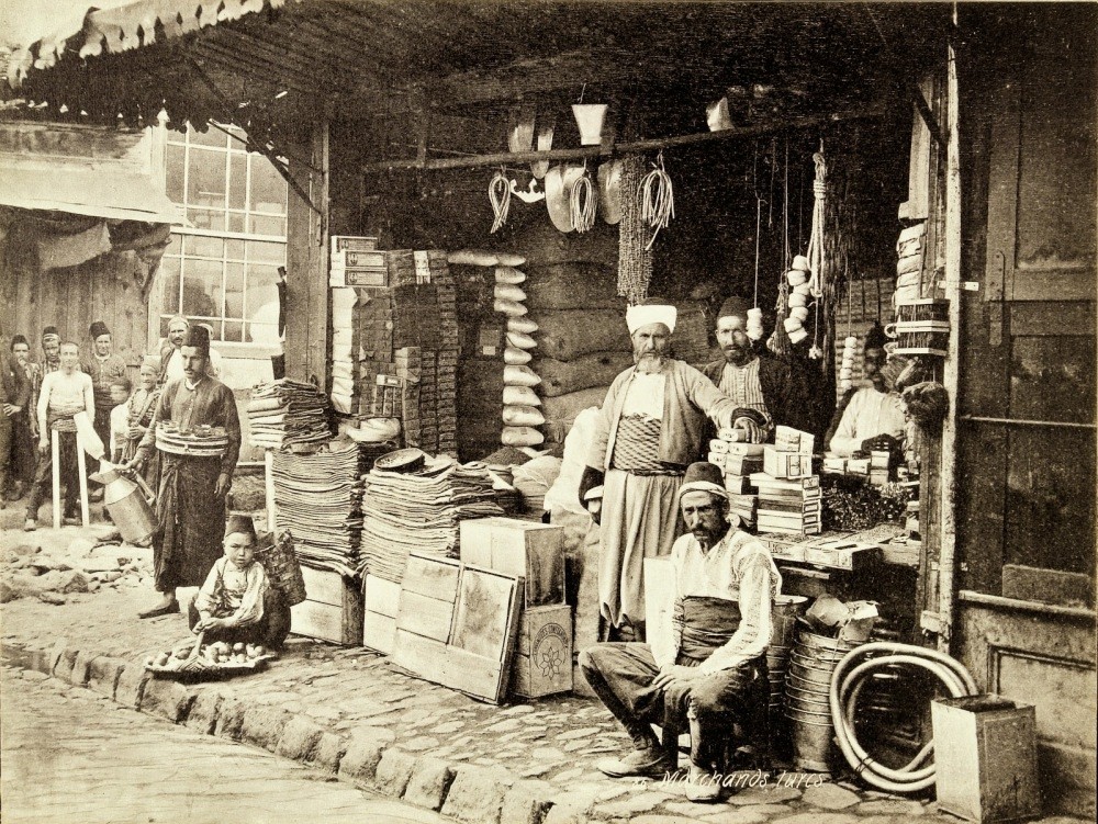 Ottoman tradesmen posing for the camera in front of a grocery store.