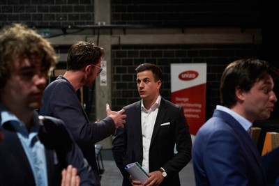 Vlaams Belang party candidate Dries van Langenhove speaks with attendees