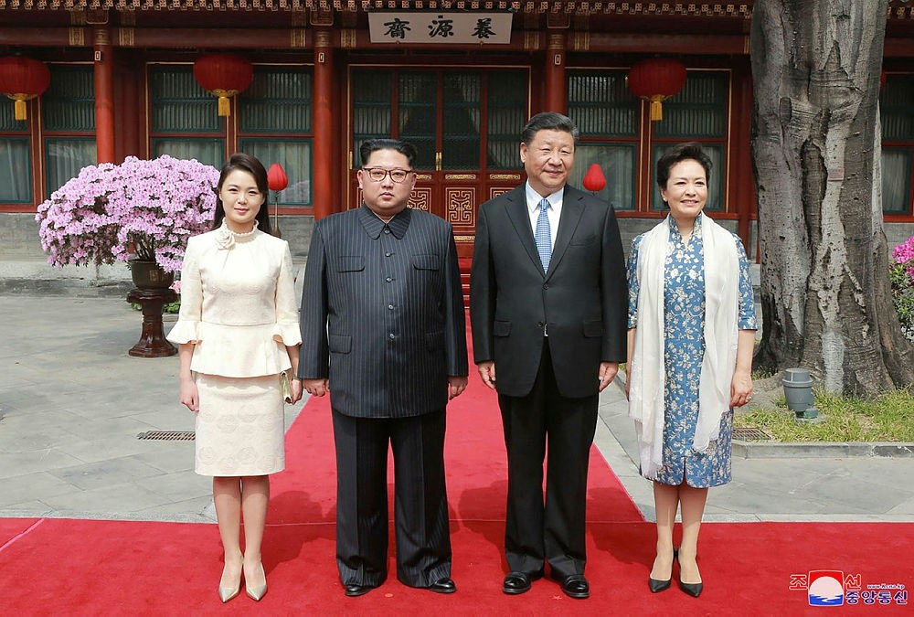 This picture from North Korea's official Korean Central News Agency (KCNA) taken on March 27, 2018 and released on March 28, 2018 shows China's President Xi Jinping (2nd R), his wife Peng Liyuan (R), North Korean leader Kim Jong Un (2nd L) and his wife Ri Sol Ju (L) posing for a picture in Beijing.