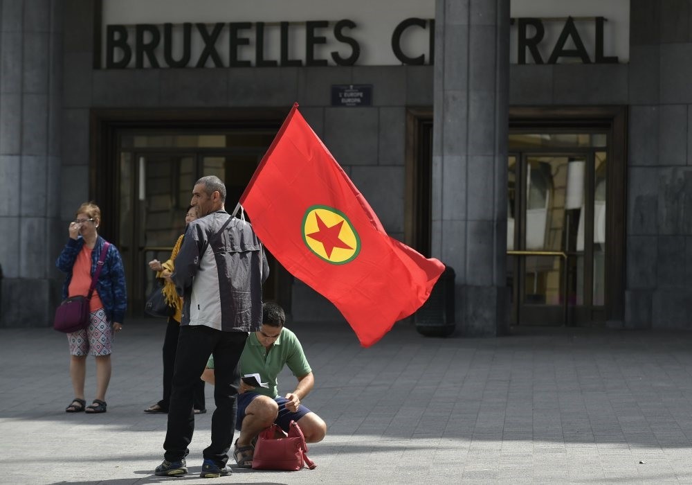 A PKK supporter carries the terrorist group's flag at an August 2015 demonstration in Brussels, Belgium.