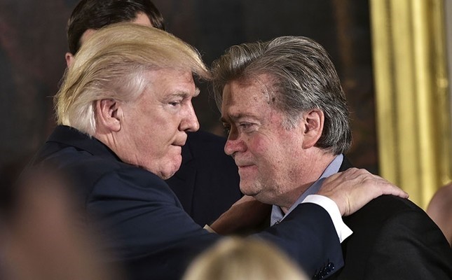 This Jan. 22, 2017 photo shows US President Donald Trump (L) congratulating Senior Counselor to the President Stephen Bannon during the swearing-in of senior staff in the East Room of the White House on January 22, 2017 in Washington, DC. (AFP Photo)
