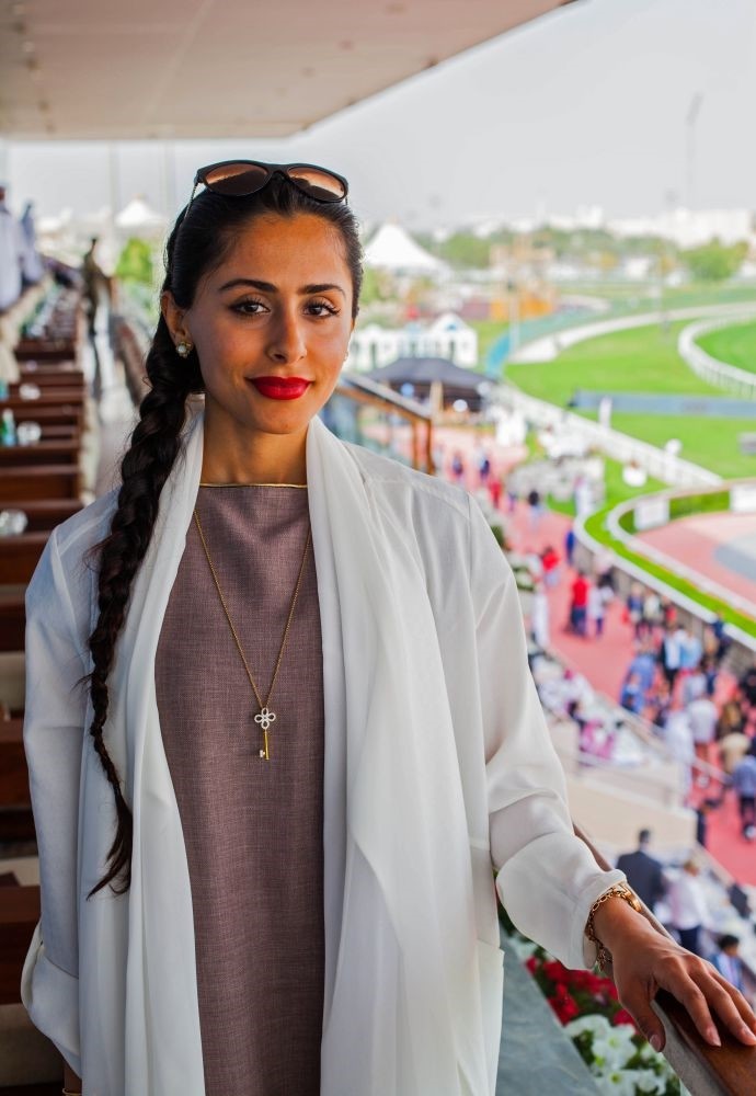 Female Qatari jockey Maryam Al-Subaiey poses for a picture during an interview.
