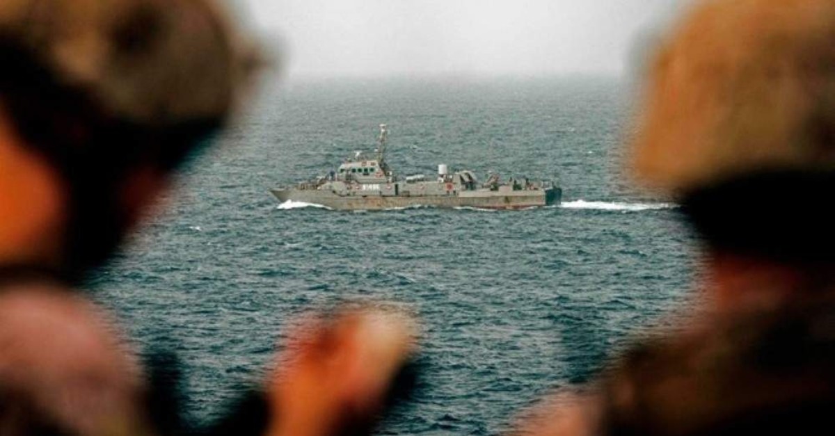 This handout picture taken by the US Navy on August 12, 2019, shows US sailors aboard an amphibious transport dock ship as they keep watch on Iranian fast attack craft in the Strait of Hormuz. (AFP Photo)