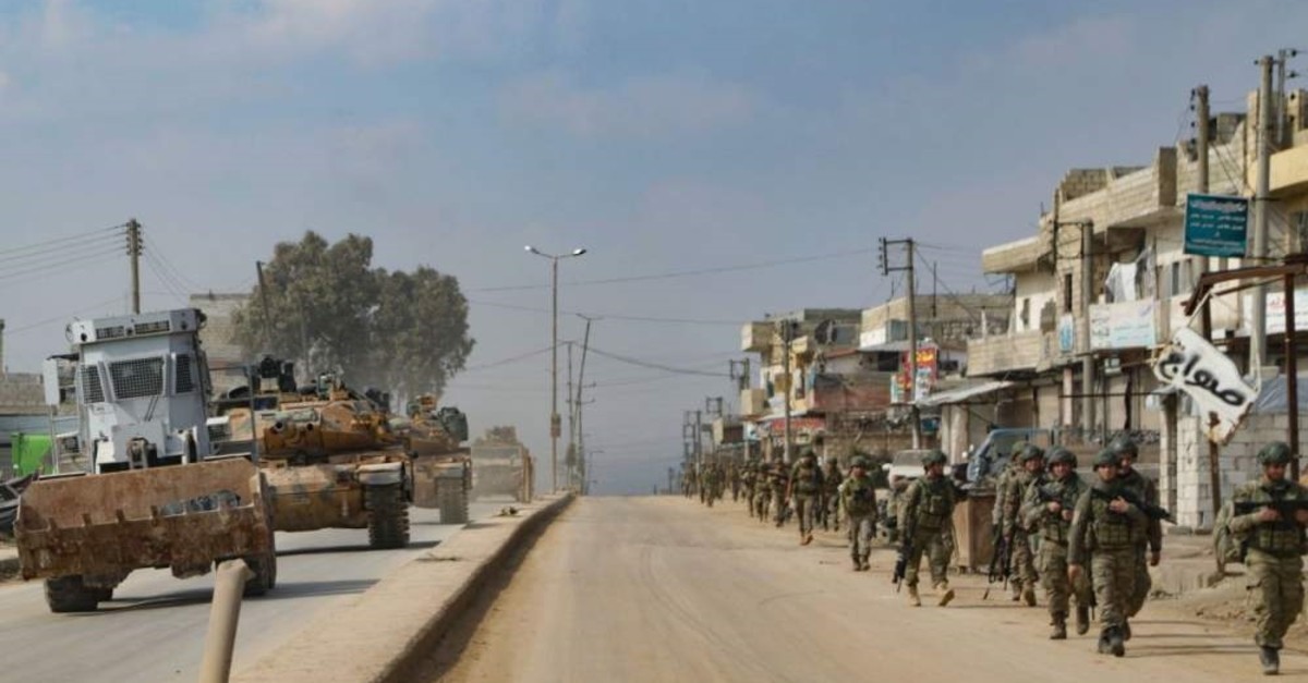 Turkish troops patrol on foot and in military vehicles in the town of Atareb in the western countryside of Syria's Aleppo province, Feb. 19, 2020. (AFP Photo)