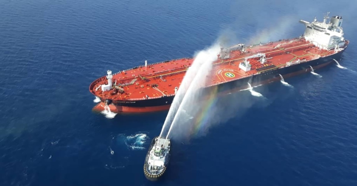 An Iranian Navy vessel attempts to control the fire aboard the Norwegian ,Front Altair, tanker in the Gulf of Oman, June 13, 2019.