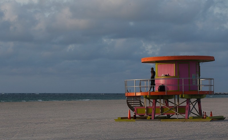 A person stands on a lifeguard stand at an empty South Beach, Friday, Sept. 8, 2017 in Miami Beach, Fla. (AP Photo)