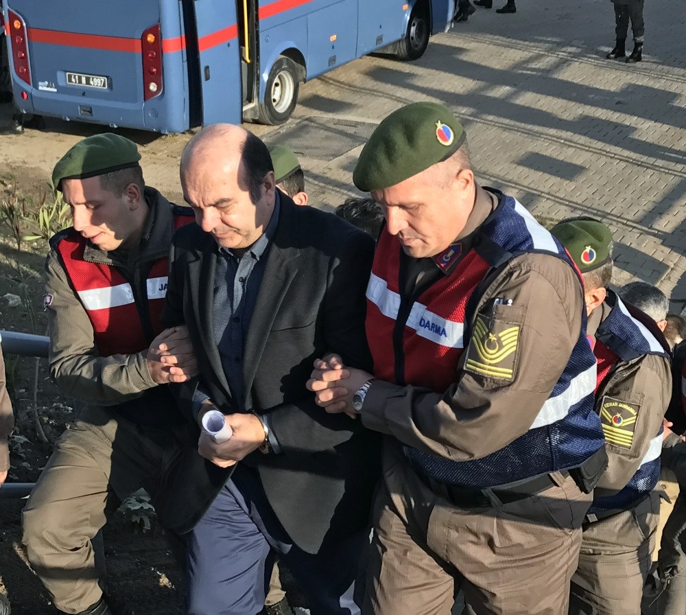 Gendarmerie officers escort u0130mren to the courthouse for a coup trial hearing.