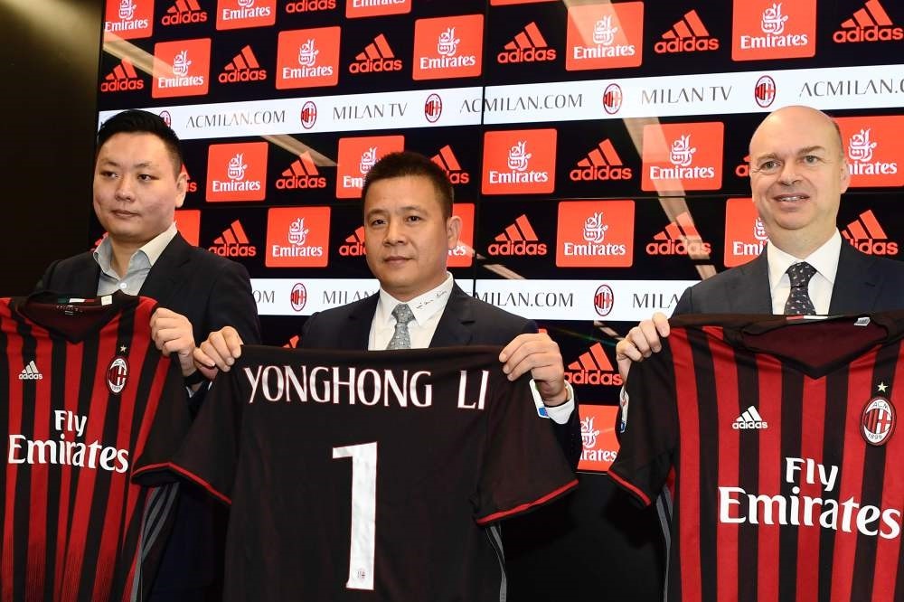 Head of Rossoneri Sport Investment Lux, Chinese businessman and AC Milan's new owner, Yonghong Li (C) poses with Italian businessman Marco Fassone (R) and RSIL representative David Han Li (L) during a press conference, on Friday, in Milan. (AFP Photo