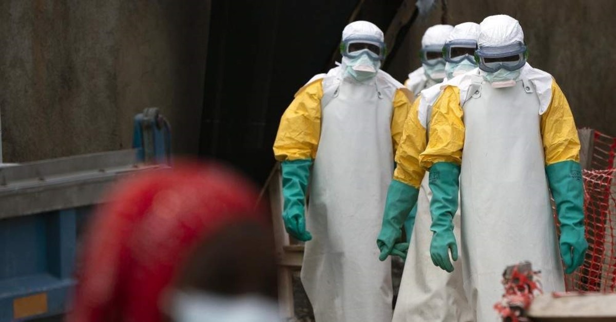 FILE - In this Tuesday, July 16, 2019 file photo, health workers dressed in protective gear begin their shift at an Ebola treatment center in Beni, Congo DRC.  (AP Photo)