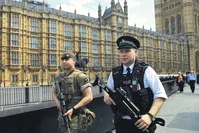 British Army soldiers along with armed police patrol the streets near the Houses of Parliament in London, Britain, May 24.