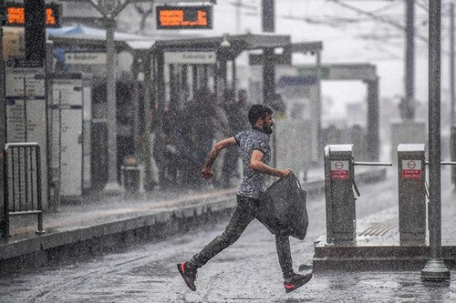 A man runs under a heavy rain in Istanbul on Sept. 11, 2018. (AFP Photo)