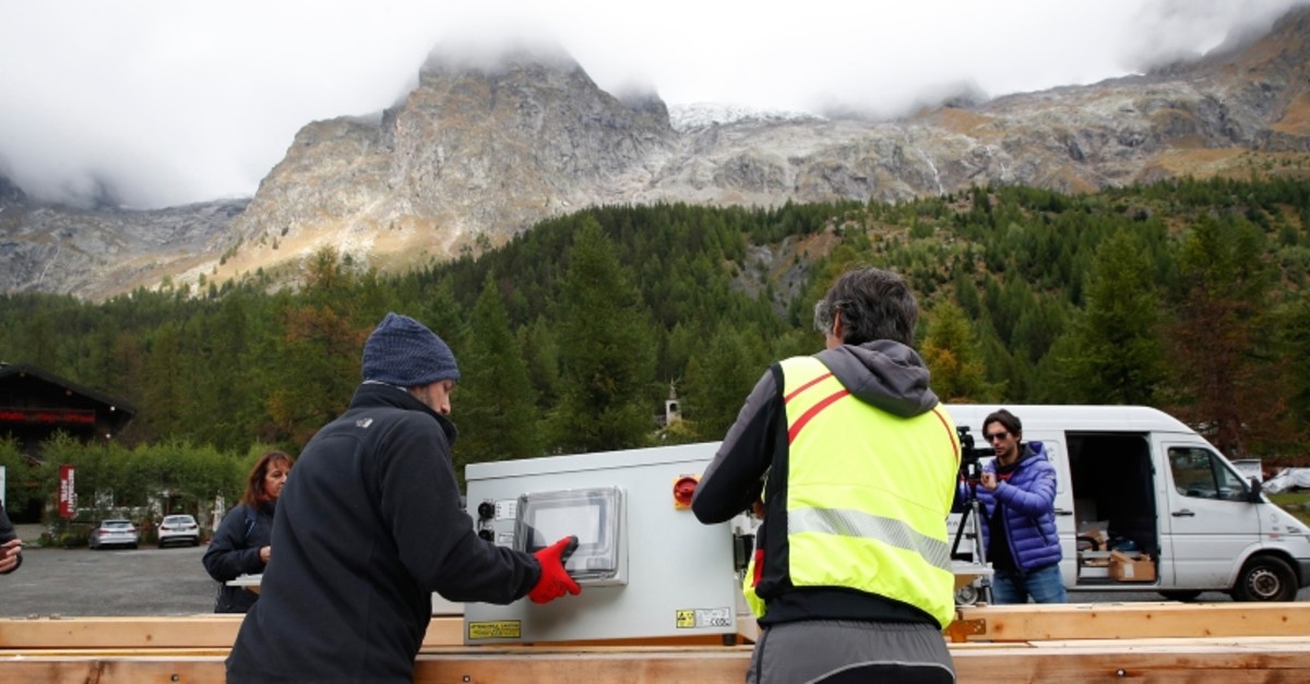 Workers place a radar in a box to be carried by a helicopter to the Planpincieux glacier located in the Alps on the Grande Jorasses peak of the Mont Blanc massif, above the Val Ferret (AP Photo)