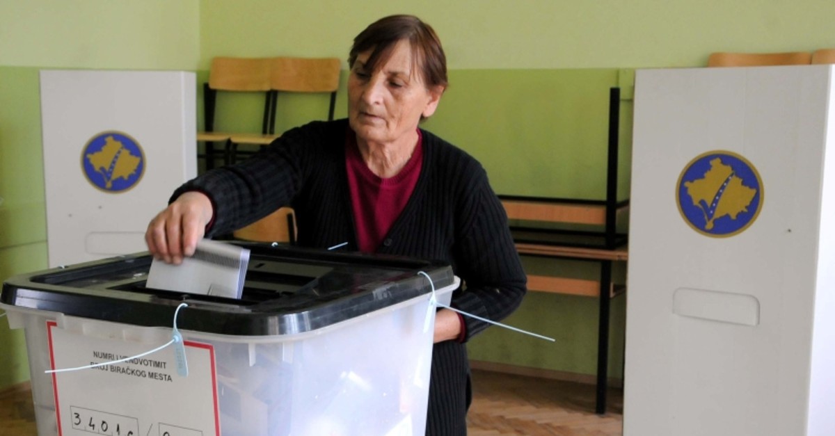 A woman casts her vote into a ballot box at a polling station in Gracanica, near Pristina, Kosovo, Oct. 6, 2019. (Reuters Photo)