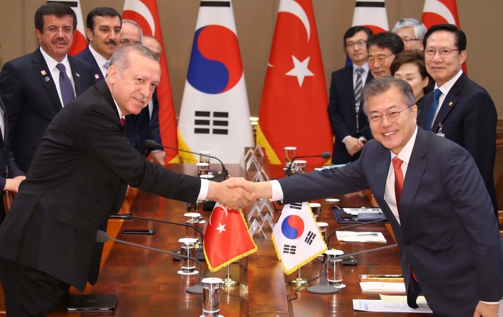 South Korean President Moon Jae-in (R) shakes hands with Turkish President Recep Tayyip Erdou011fan (L) during their expanded summit meeting in Seoul, South Korea, yesterday.