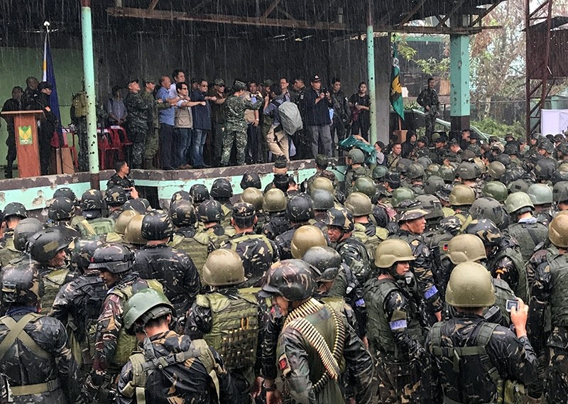 Philippine President Rodrigo Duterte, center, is joined by other government and military officials as they visit troops in Marawi, southern Philippines on Tuesday Oct. 17, 2017 (AP Photo)
