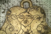 In this undated photo provided by the Greek Culture Ministry on Tuesday, Dec. 17, 2019, a golden pendant of the Egyptian goddess Hathor is seen that was found in a 3,500-year-old tomb discovered near the southwestern Greek town of Pylos. (Greek Culture Ministry via AP)