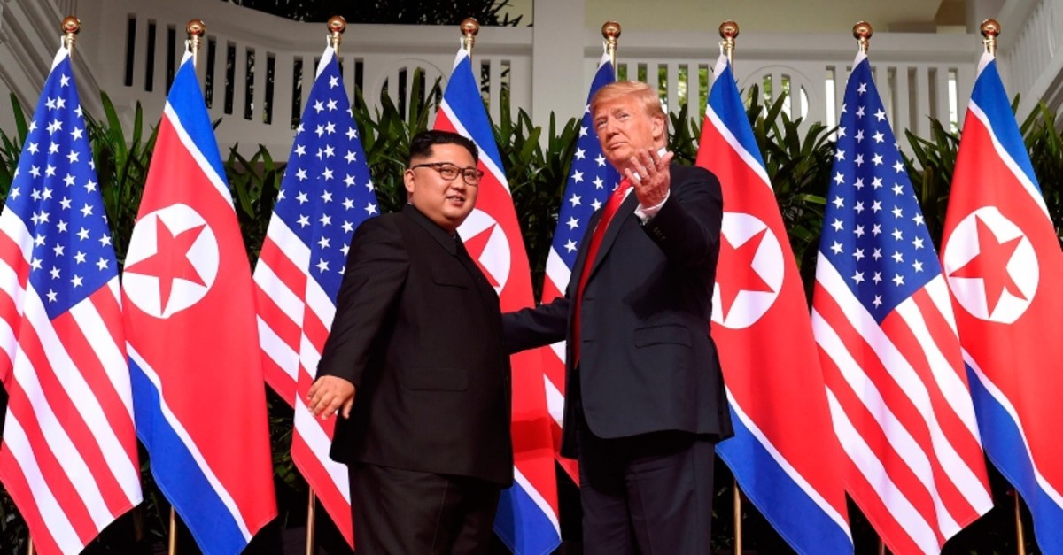 U.S. President Donald Trump (R) gestures as he meets with North Korea's leader Kim Jong Un (L) at the start of their historic US-North Korea summit, at the Capella Hotel on Sentosa island in Singapore on June 12, 2018. (AFP Photo)