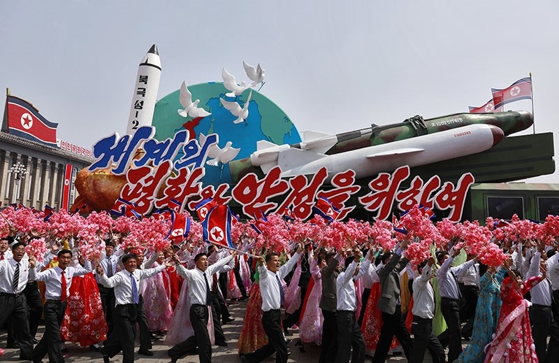 North Korean people waving flowers march with a float carrying replicas of missiles during a parade for the 'Day of the Sun' festival on Kim Il Sung Square in Pyongyang, North Korea, 15 April 2017.  (EPA Photo)
