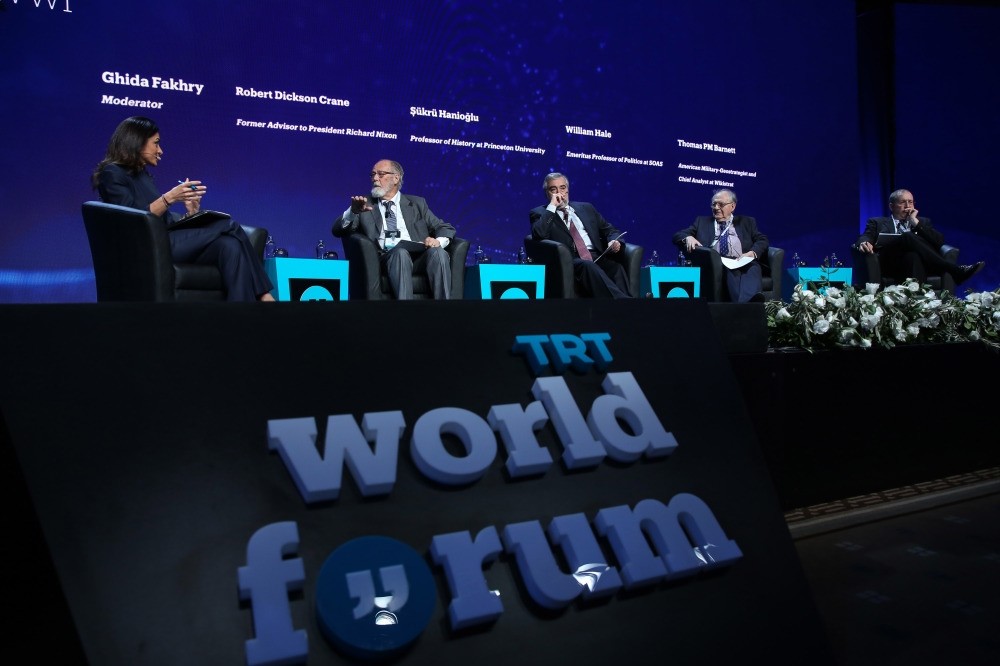 Robert Dickson Crane (second L), Professor u015eu00fckru00fc Haniou011flu of Princeton University (C), analyst Thomas Barrett (R) and Professor William Hale of SOAS University of London (second R) attends a panel moderated by TRT World presenter Ghida Fakhry (L).