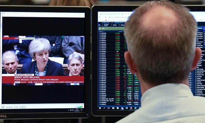 CMC Markets chief market analyst Michael Hewson looks at financial data at the offices of CMC Markets in the City of London on December 10, 2018. (AFP Photo)