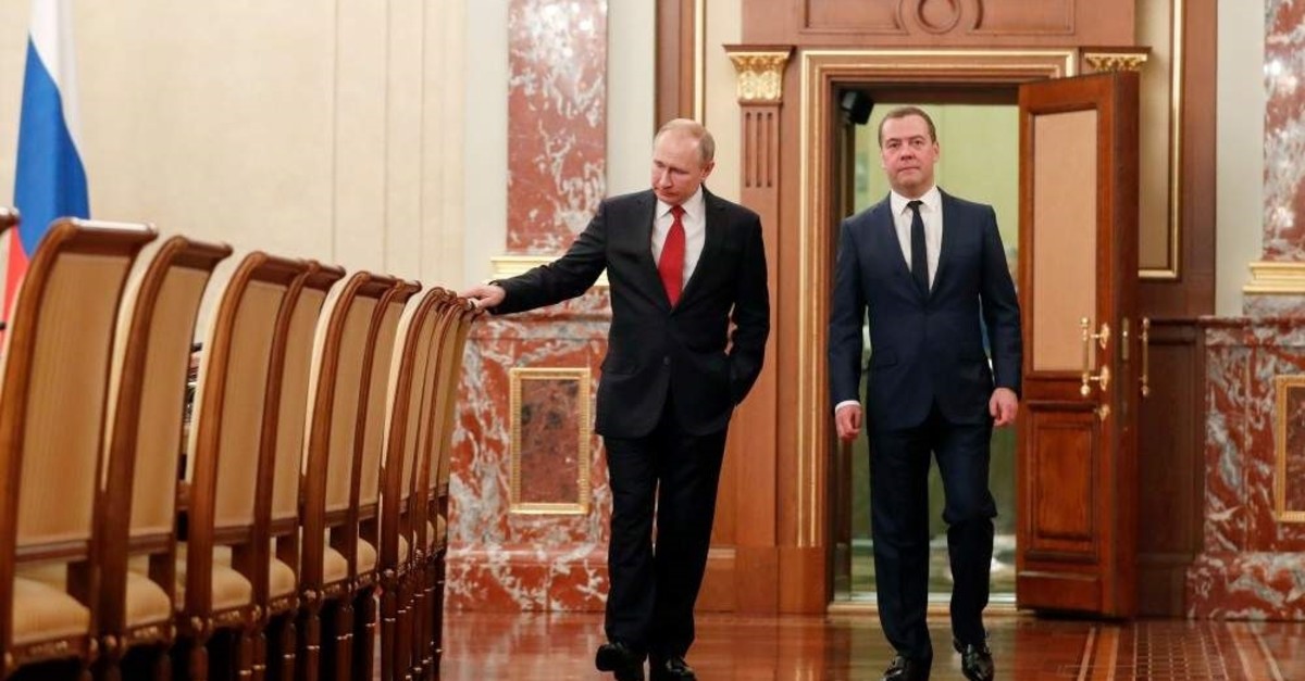 Russian President Vladimir Putin and former Prime Minister Dmitry Medvedev walk before a meeting with members of the government in Moscow, Jan. 15, 2020. (AFP Photo)