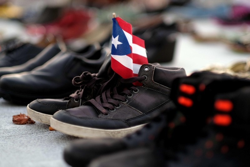 In this file photo taken on June 1, 2018 a view of a Puerto Rican flag placed on a pair of shoes among hundreds displayed in memory of those killed by Hurricane Maria in front of the Puerto Rican Capitol, in San Juan. (AFP Photo)