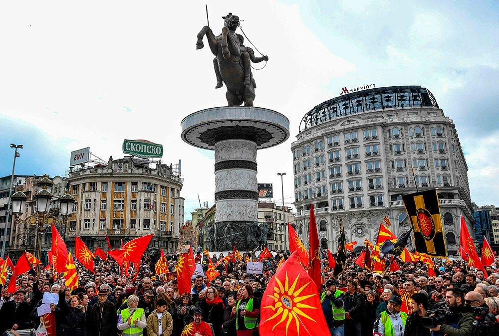People wave Macedonian flags during a protest in a central square in Skopje on March 4, 2018. (AFP Photo)