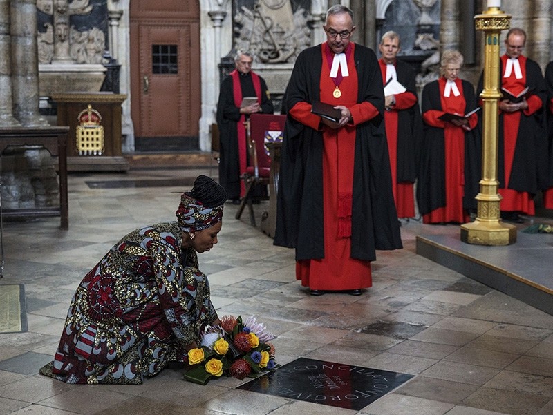 Zamaswazi Dlamini-Mandela, granddaughter of former South African leader Nelson Mandela, lays a wreath beside the memorial stone dedicated to the former South African President during a service to mark the centenary of his birth, at Westminster Abbey in London.