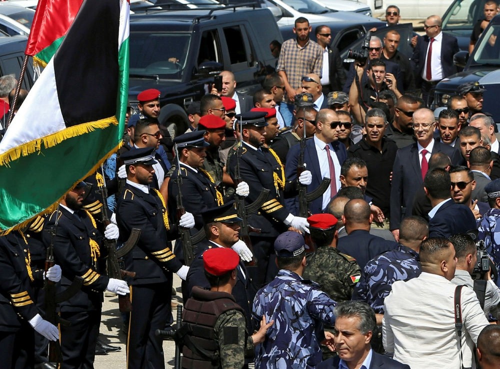 Palestinian Prime Minister Rami Hamdallah reviews an honor guard on his arrival to the Palestinian side of the Beit Hanoun border crossing in the northern Gaza Strip, Oct. 2.