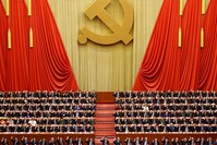 Chinese President Xi Jinping (front row, center) and fellow delegates raise their hands as they take a vote at the closing session of the 19th National Congress of the Communist Party of China, in Beijing (Reuters Photo)