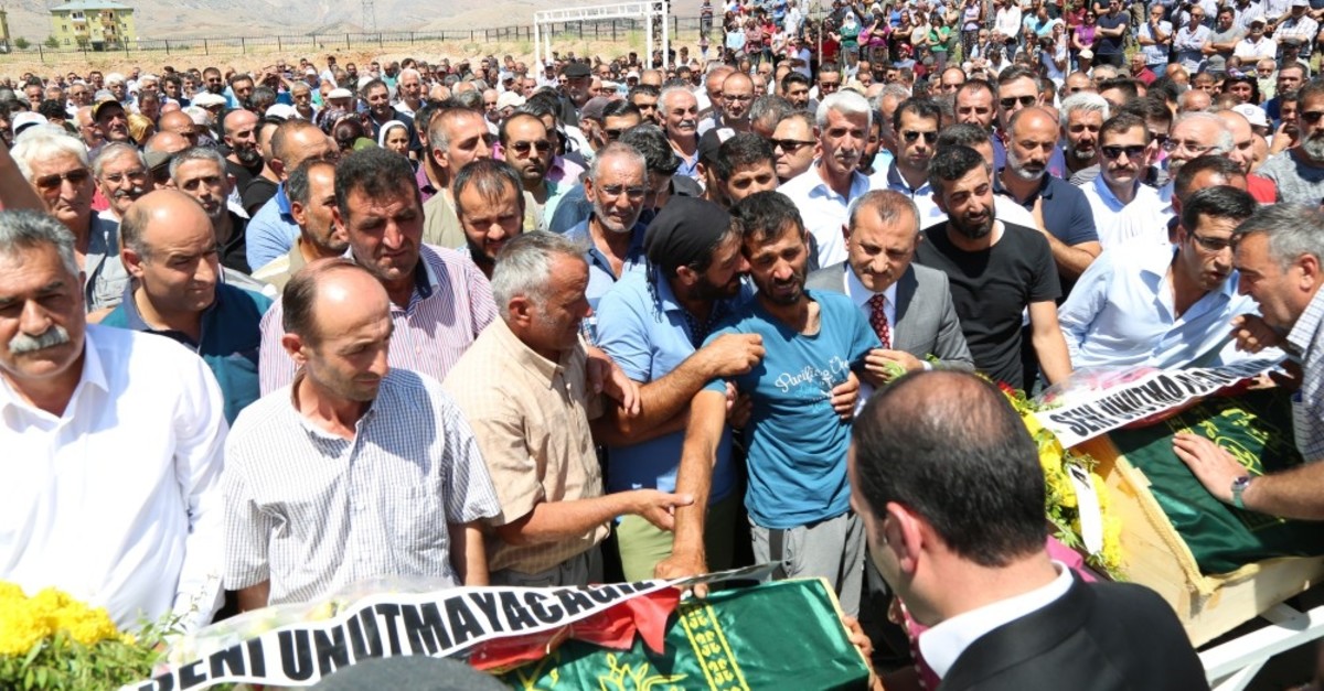 People support the father of the PKK victim siblings who feels faint during the funeral, July 16, 2019.